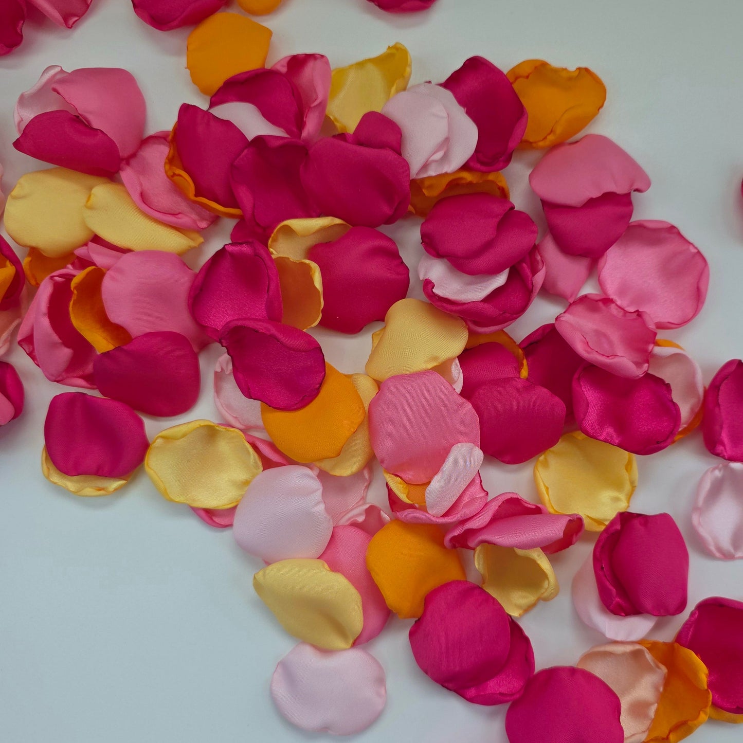 Orange, Yellow, Pink and Fuchsia rose petals for a Whimsical wedding theme color ideas, Petals scattered on tablescape, flower girl tossing, confetti scatter, backdrop accents, sunset wedding color ideas
