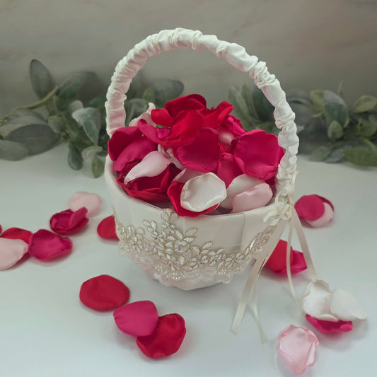 Red, fuchsia, pink and white rose petals in ivory flower girl basket, for wedding aisle decor, flower girl toss, valentine date night tablescape decor, future bride color scheme ideas, confetti