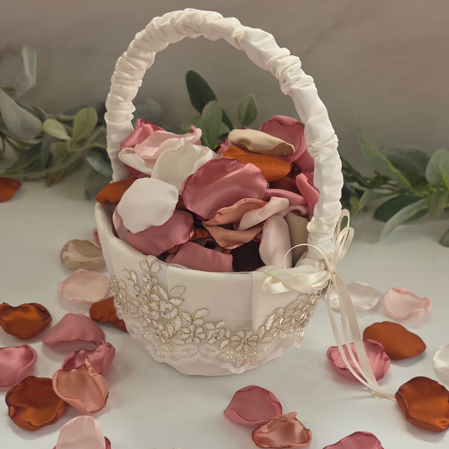 Auburn, burnt orange, beige, blush pink rose petals in Ivory basket for flower girl tossing, aisle decor, flatlays, backdrop accents or tablescape table scatter, decor ideas. A fall color palette for the future bride planning a western, rustic wedding ceremony or natural, nuetral colored bridal shower event