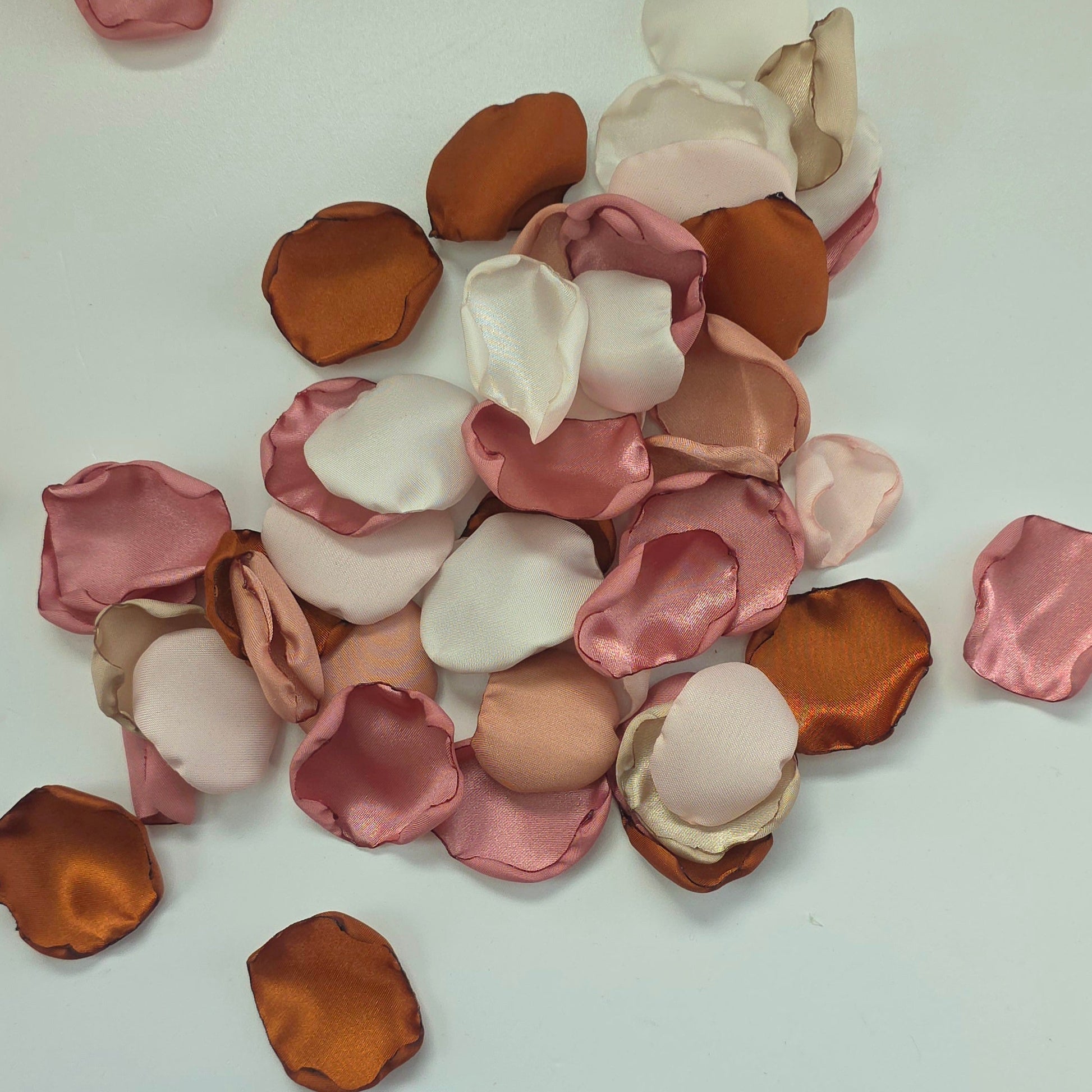 Auburn, burnt orange, beige, blush pink rose petals for flower girl tossing, aisle decor, flatlays, backdrop accents or tablescape table scatter, decor ideas. A fall color palette for the future bride planning a western, rustic wedding ceremony or natural, nuetral colored bridal shower event