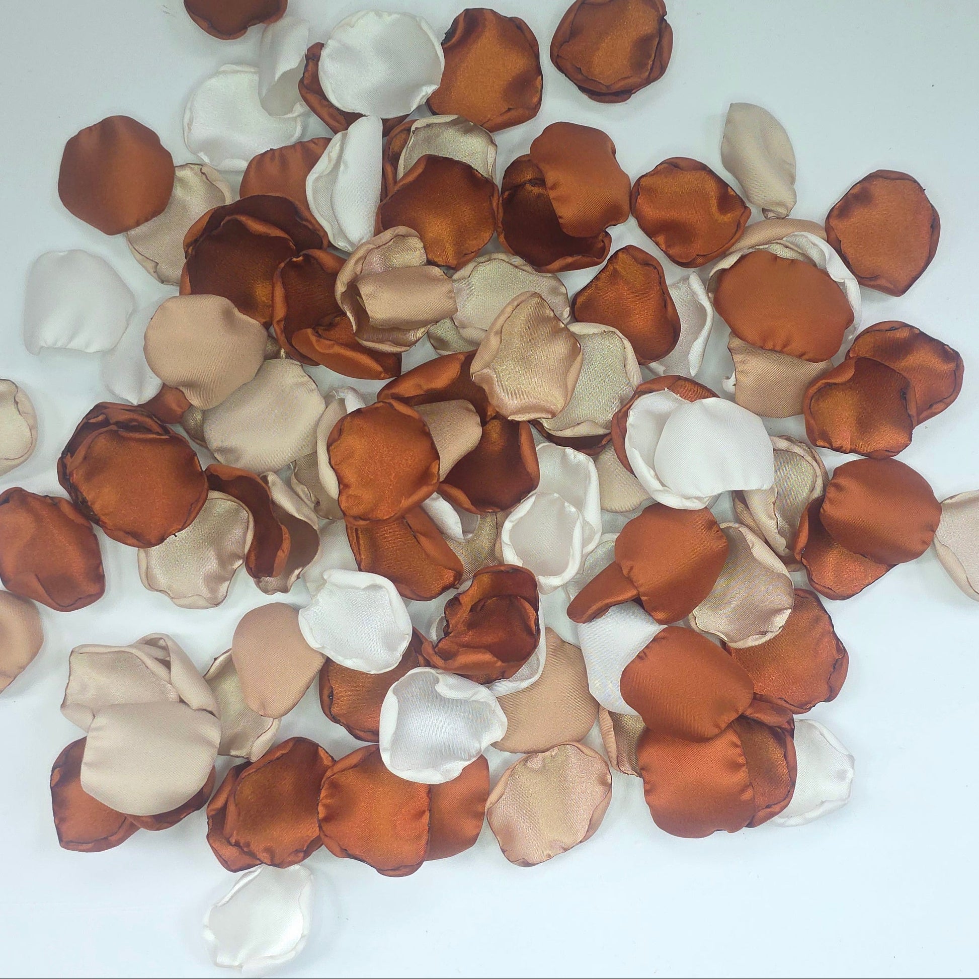 A mix of rose petals featuring an Auburn, terracotta, burnt orange color palette that includes beige, taupe and off white petals. Perfect for flower girl baskets and tossing, aisle decor, flatlays, reception tablescape decorations, table scatter and confetti toss. Wedding decor Ideas for the future bride planning a fall wedding ceremony or a boho western bridal shower event.