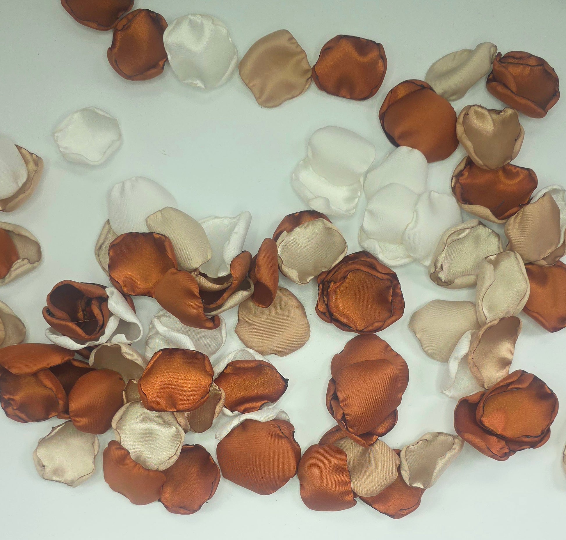 A mix of rose petals featuring an Auburn, terracotta, burnt orange color palette that includes beige, taupe and off white petals. Perfect for flower girl baskets and tossing, aisle decor, flatlays, reception tablescape decorations, table scatter and confetti toss. Wedding decor Ideas for the future bride planning a fall wedding ceremony or a boho western bridal shower event.