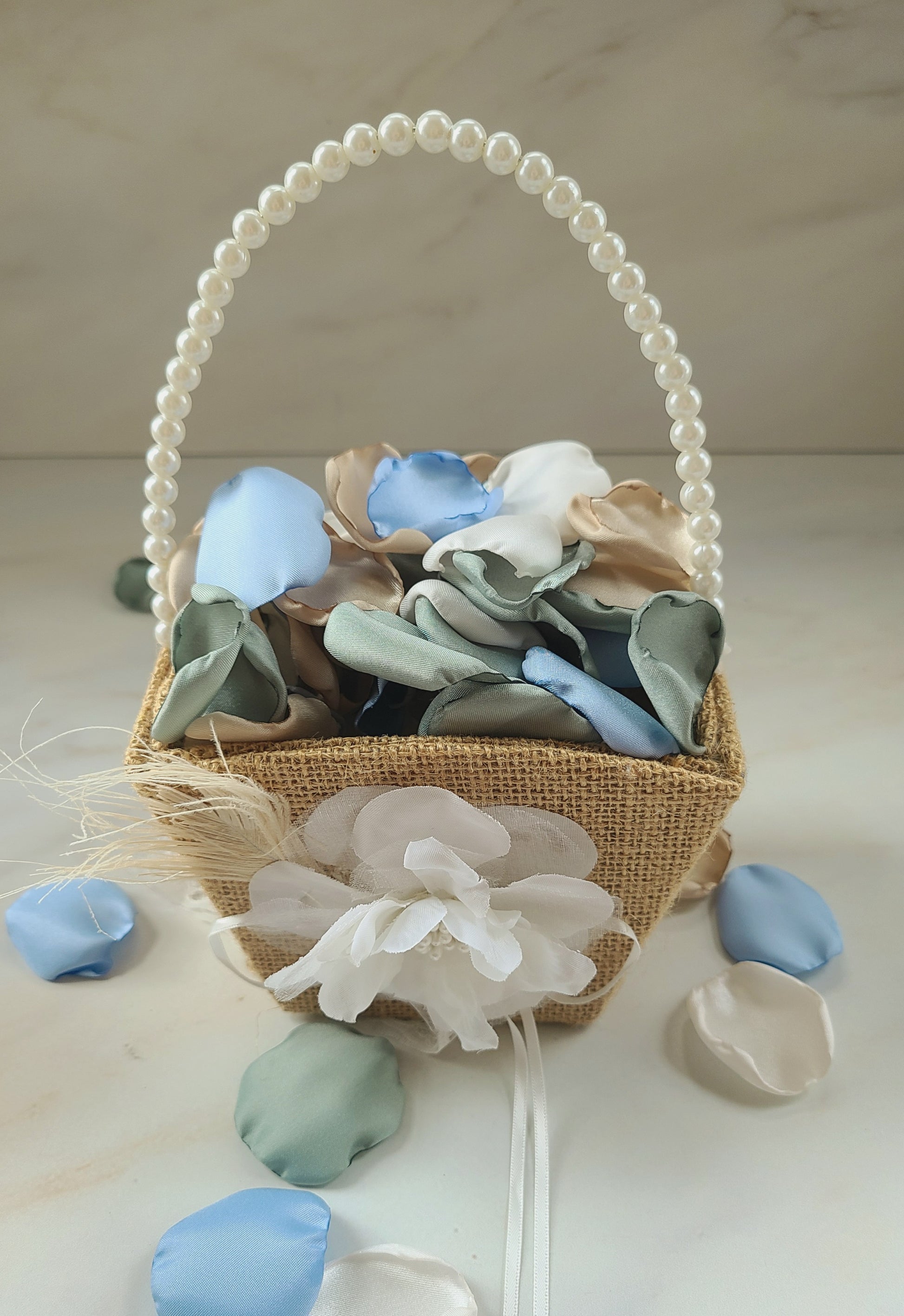Boho flower girl basket filled with Sky blue, ivory, beige and dusty sage rose petals