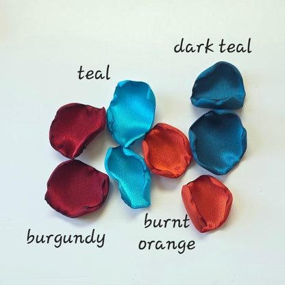 A mix of  burgundy, burnt orange, dark and light teal rose petals for flower girl tossing, baskets, aisle decor or tablescape  confetti scatter. Ideas for future brides planning a jewel toned wedding ceremony or fall bridal shower event.