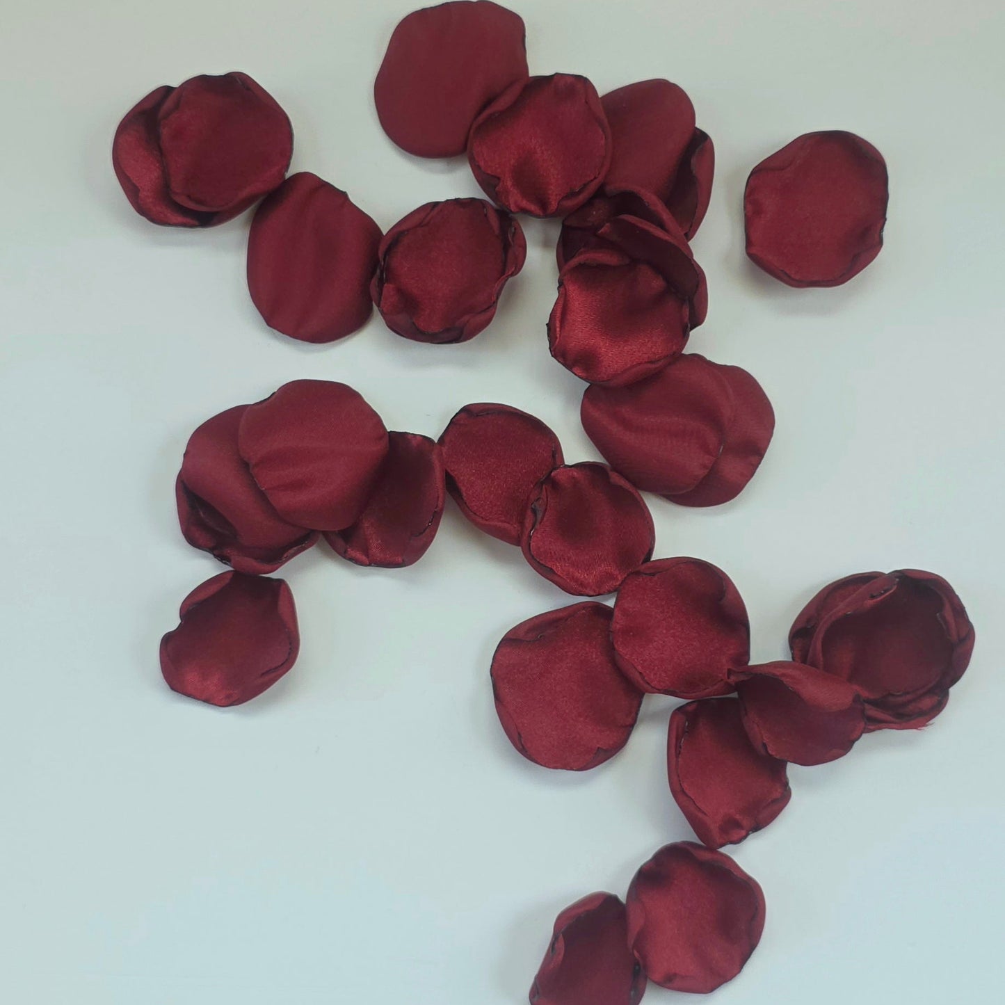 Burgundy, White rose petals for flower girl tossing, aisle decor, classic fall wedding decor. Ideas for future brides planning an elegant wedding ceremony or bridal shower event.