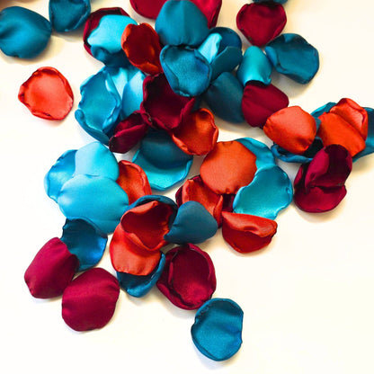 A mix of  burgundy, burnt orange, dark and light teal rose petals for flower girl tossing, baskets, aisle decor or tablescape  confetti scatter. Ideas for future brides planning a jewel toned wedding ceremony or fall bridal shower event.