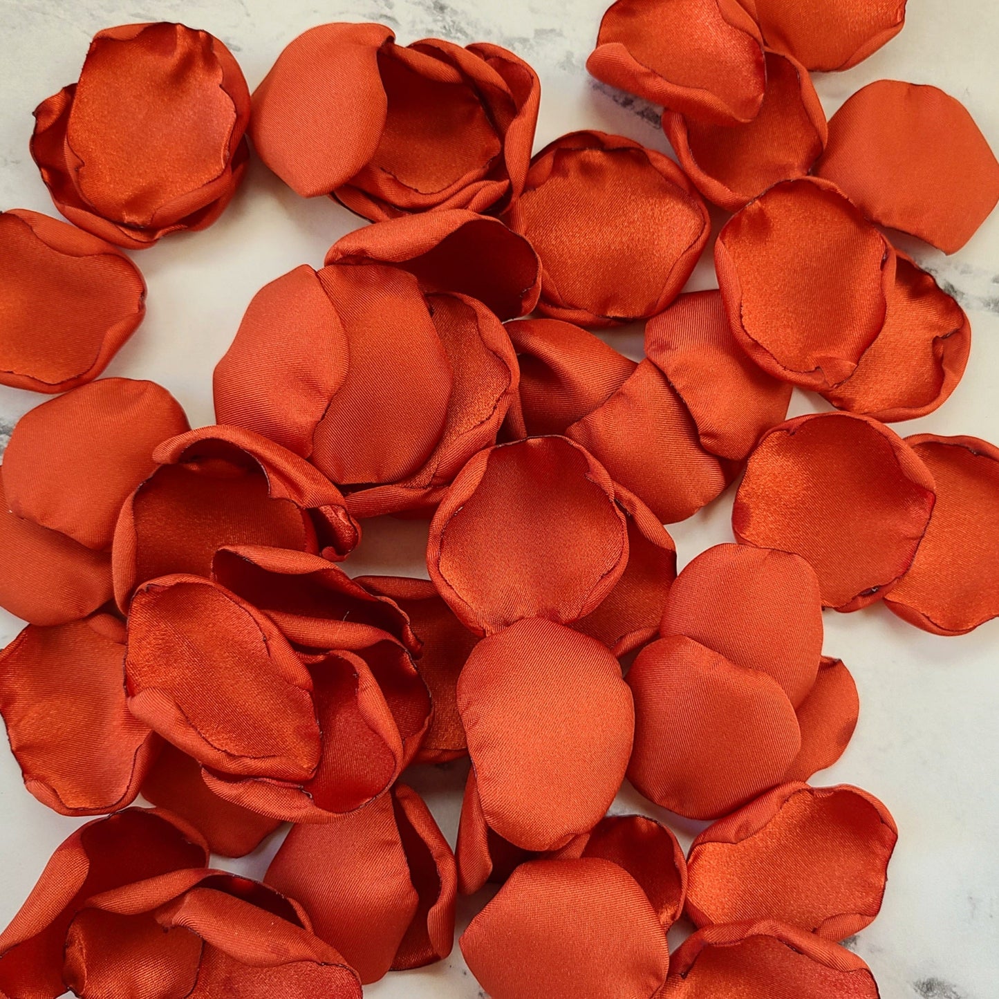 Rust rose petals for a burnt orange fall wedding theme, flower girl basket