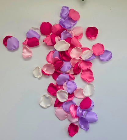 Lilac Purple, pinks , ivory and fuchsia rose petals on table. Used for flower girl toss, future bride ideas, confetti scatter on reception tables, baskets, wedding aisle decor