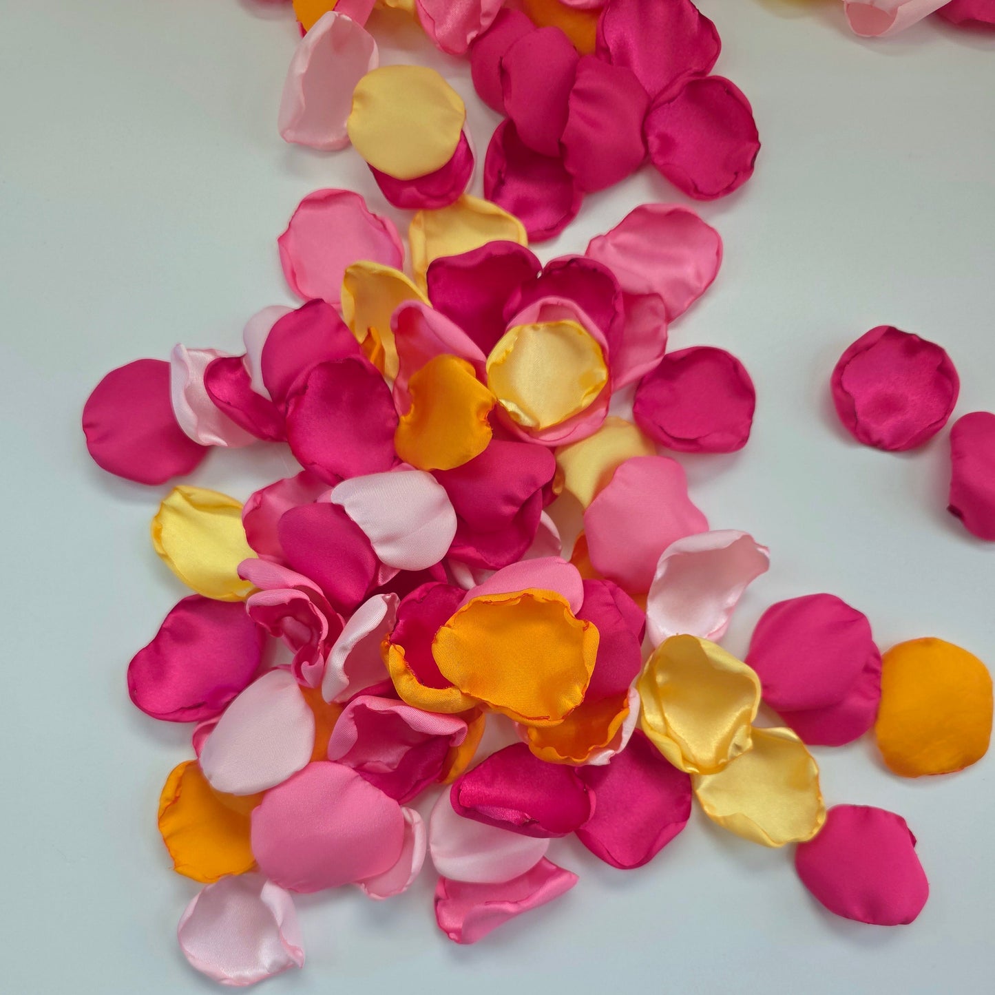 Orange, Yellow, Pink and Fuchsia rose petals for a Whimsical wedding theme color ideas, Petals scattered on tablescape, flower girl tossing, confetti scatter, backdrop accents, sunset wedding color ideas