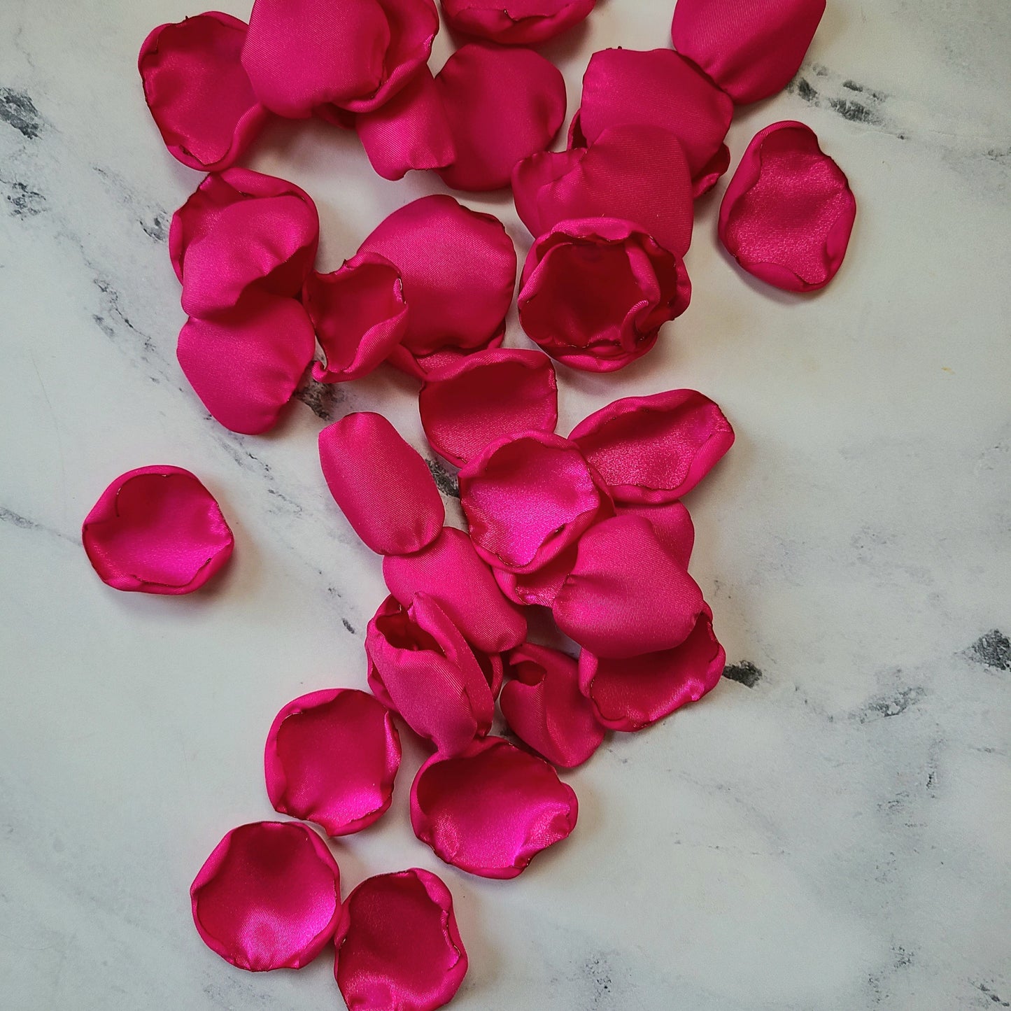 Fuchsia pink and ivory rose petals showcased on tabletop. Perfect for tablecapes decor, flower girl toss, wedding aisle decor, confetti scatter, amazing additions to ceremony backdrop props, future bride ideas