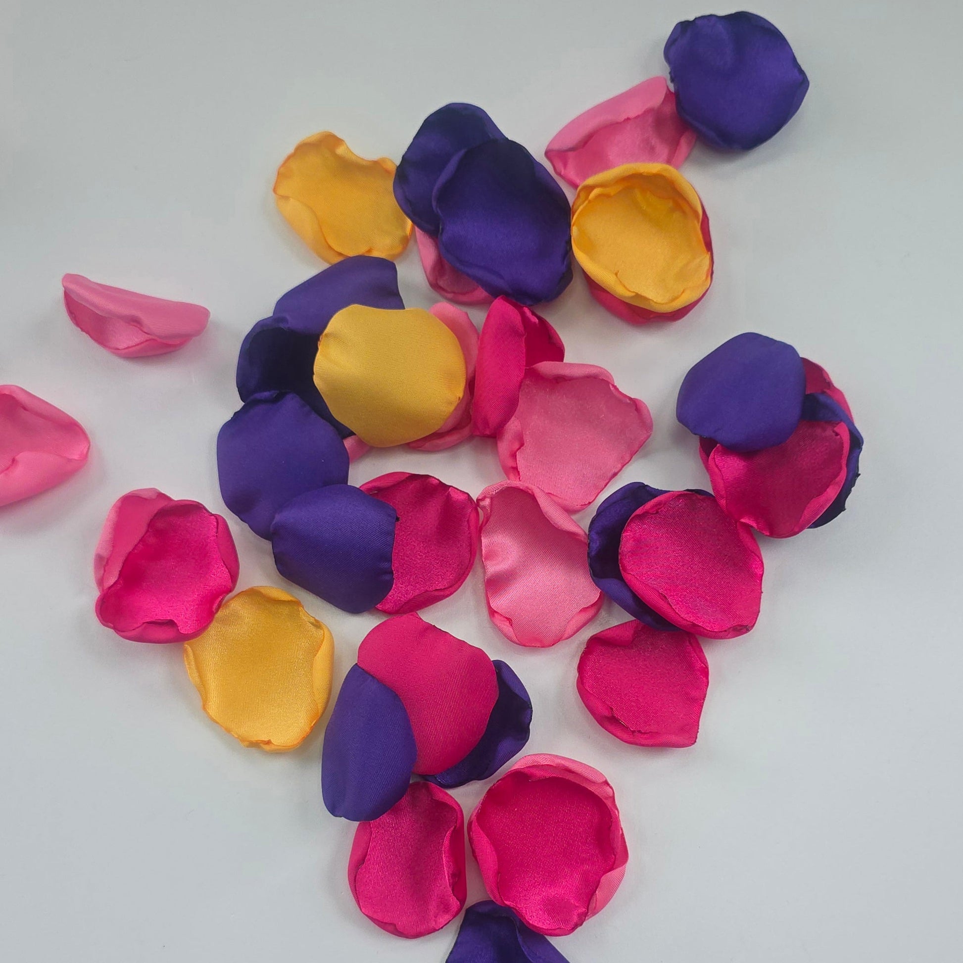 A mix of Fuchsia, Candy Pink, Dark Purple and Sunflower Yellow rose petals. For flower girl tossing,  aisle decor, reception tablescape scatter, backdrop accents or wedding decor. A bold colorful palette for future brides planning a golden hour sunset wedding ceremony or whimsical bridal shower brunch event.