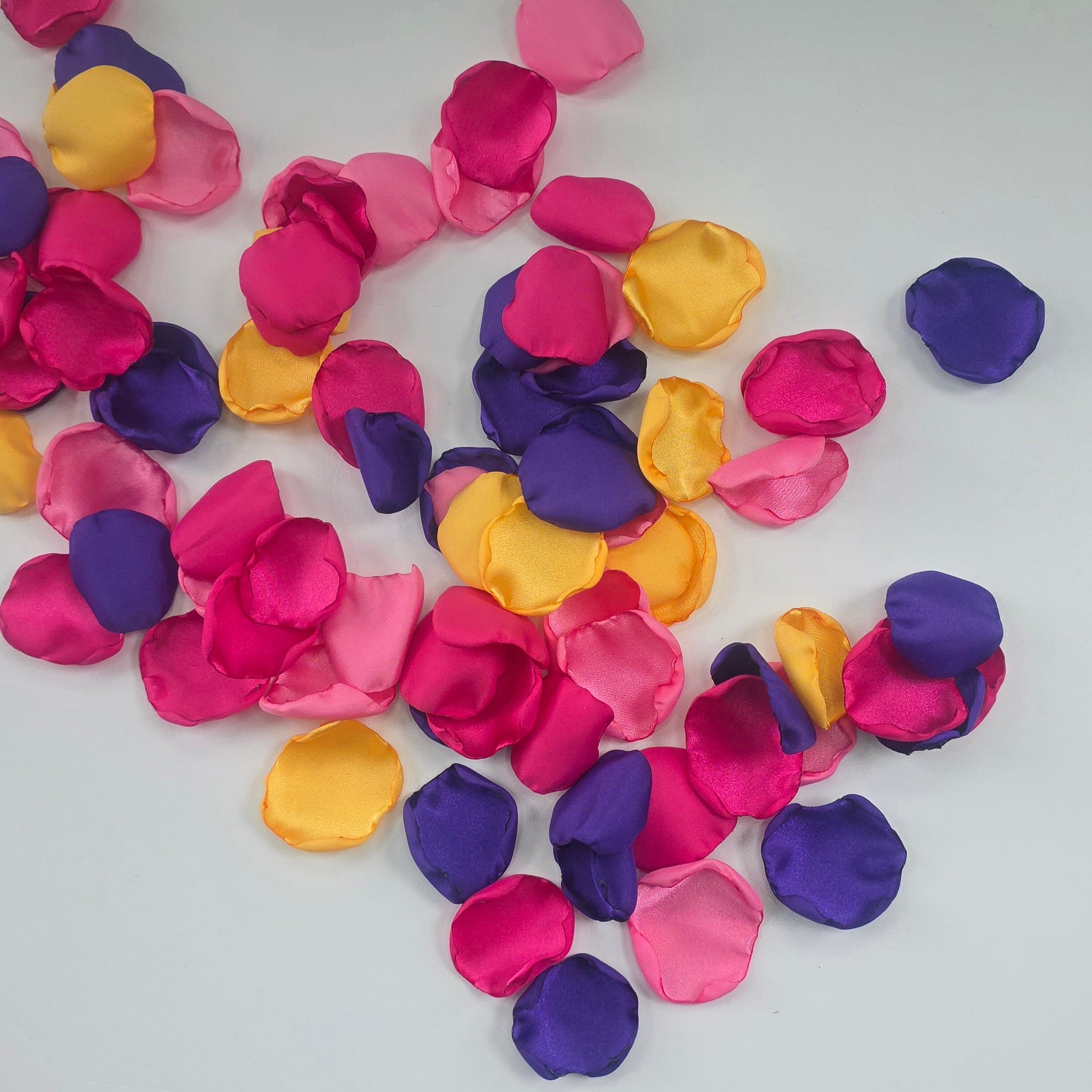 A mix of Fuchsia, Candy Pink, Dark Purple and Sunflower Yellow rose petals. For flower girl tossing,  aisle decor, reception tablescape scatter, backdrop accents or wedding decor. A bold colorful palette for future brides planning a golden hour sunset wedding ceremony or whimsical bridal shower brunch event.