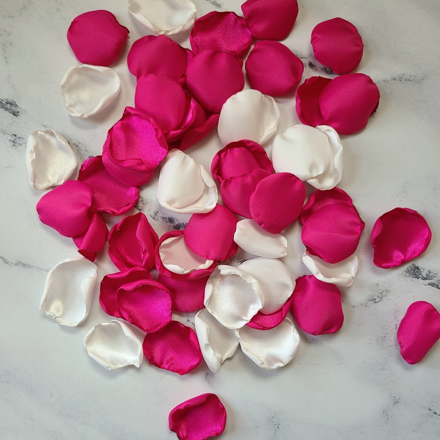 Fuchsia pink and ivory rose petals showcased on tabletop. Perfect for tablecapes decor, flower girl toss, wedding aisle decor, confetti scatter, amazing additions to ceremony backdrop props, future bride ideas