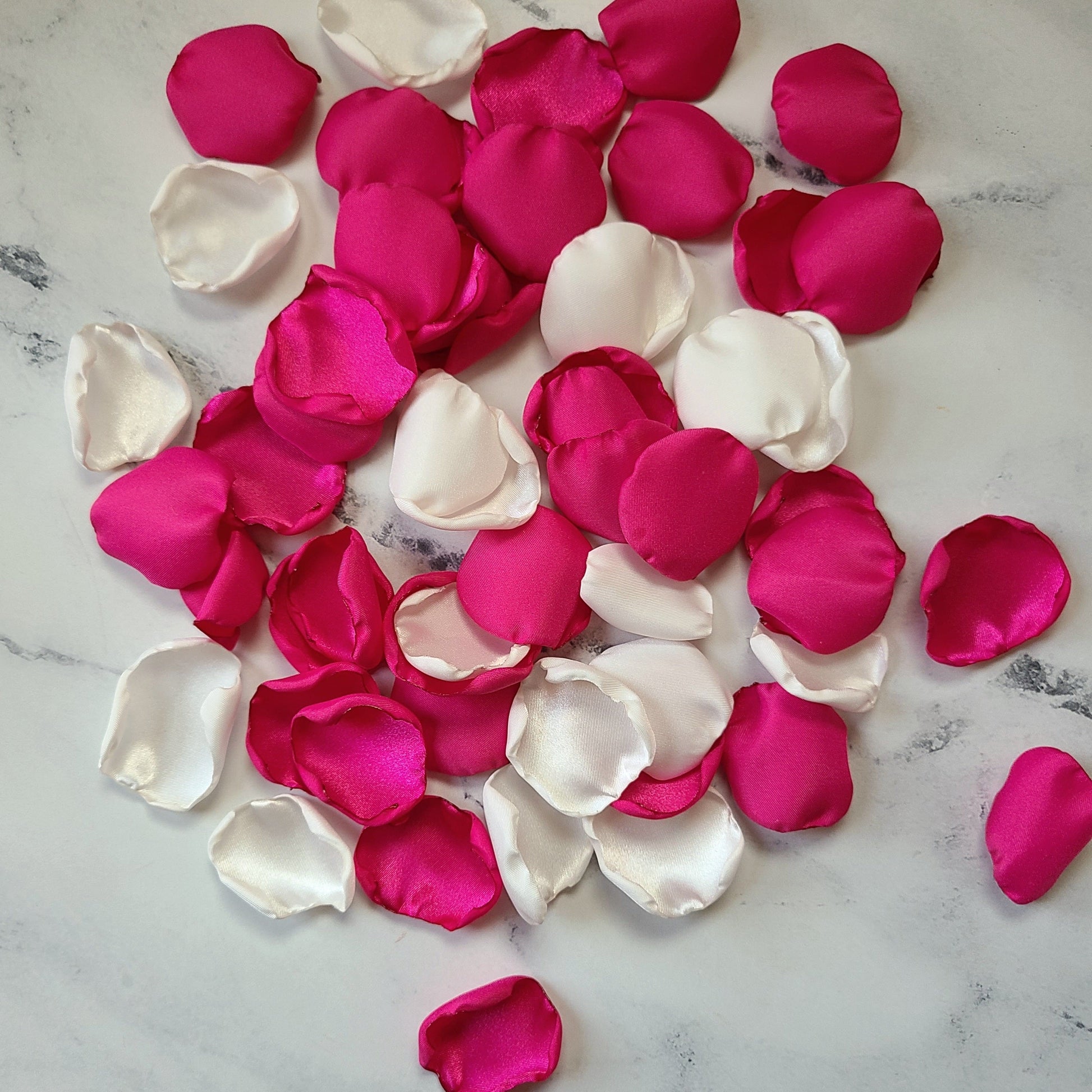 Fuchsia pink and ivory rose petals showcased on tabletop. Perfect for tablecapes decor, flower girl toss, wedding aisle decor, confetti scatter, amazing additions to ceremony backdrop props, future bride ideas