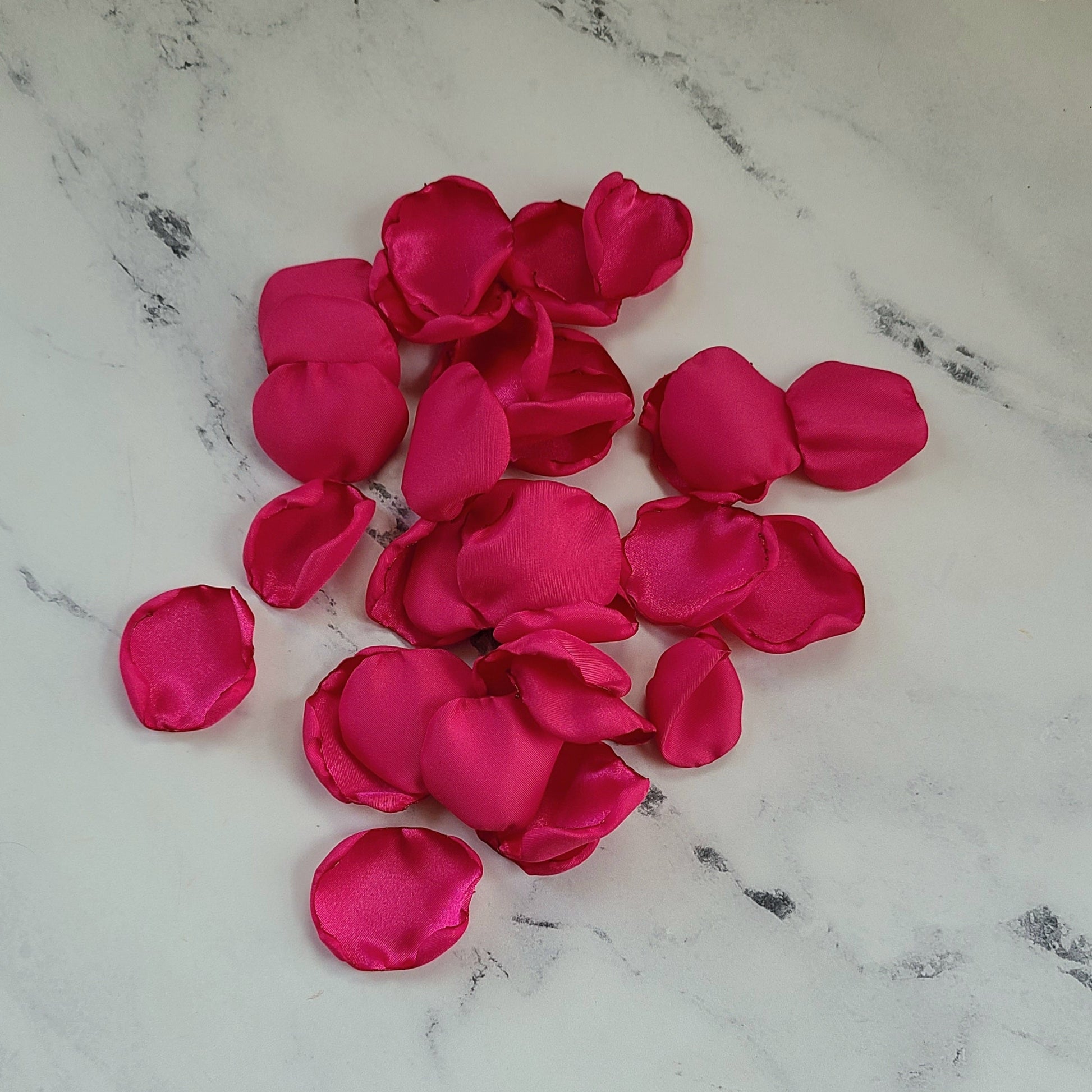 Fuchsia pink and ivory rose petals showcased on tabletop. Perfect for tablecapes decor, flower girl toss, wedding aisle decor, confetti scatter, amazing additions to ceremony backdrop props, future bride ideas