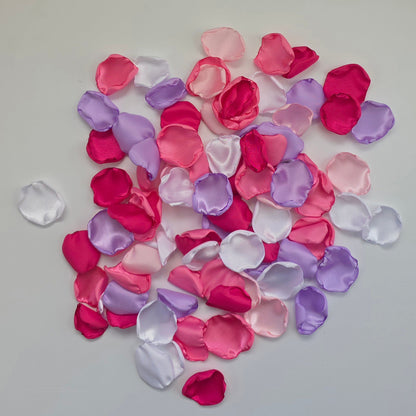 Lilac Purple, pinks, White and fuchsia rose petals on table. Used for flower girl toss, future bride ideas, confetti scatter on reception tables, baskets, wedding aisle decor