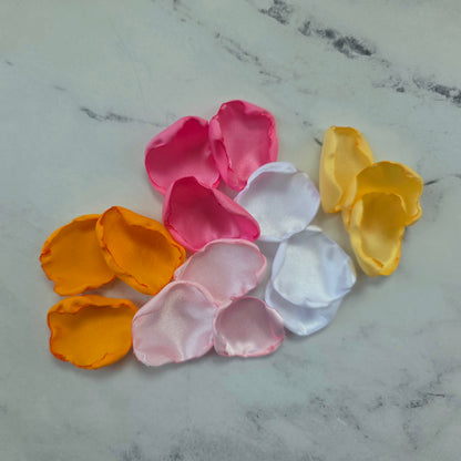 Orange, pink, white and yellow rose petals showcased on tabletop. perfect for wedding aisle decor, flower girl baskets, tablescapes, memory table accents. Sunset wedding decor , enhance your whimsical, boho, rustic western wedding ideas 