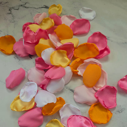Orange, pink, white and yellow rose petals showcased on tabletop. perfect for wedding aisle decor, flower girl baskets, tablescapes, memory table accents. Sunset wedding decor , enchance your whimsical, boho, rustic western wedding ideas 