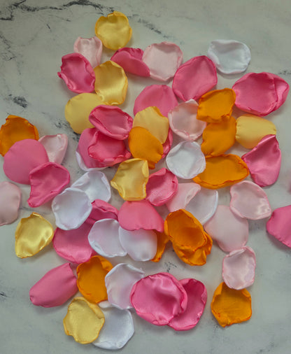 Orange, pink, white and yellow rose petals showcased on tabletop. perfect for wedding aisle decor, flower girl baskets, tablescapes, memory table accents. Sunset wedding decor , enchance your whimsical, boho, rustic western wedding ideas 