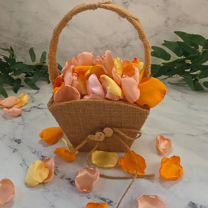 Yellow, Peach Blush, Orange rose petals showcased in a rustic, boho flower girl basket for flower girl tossing, wedding aisle decor, reception tablescapes, confetti scatter, memory table accents, Sunset Wedding Theme Ideas 
