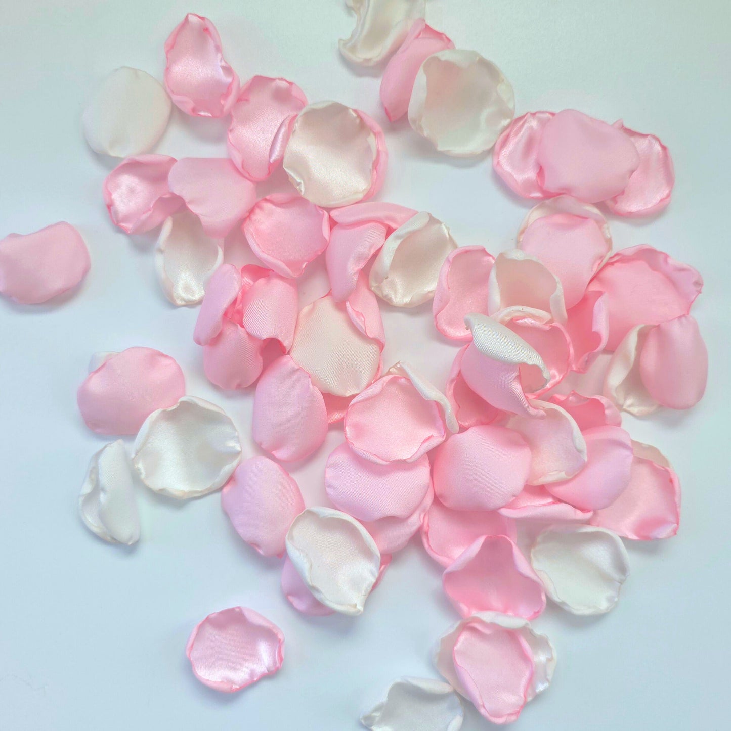 A mix of blush pink and white rose petals for a future bride using a pink wedding color palette. For flower girl toss, aisle decor, tablescape decor ideas or confetti scatter.