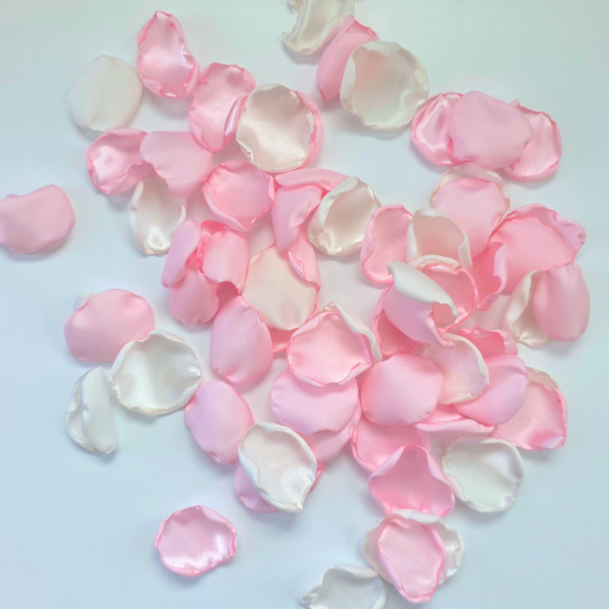 A mix of blush pink and white rose petals for a future bride using a pink wedding color palette. For flower girl toss, aisle decor, tablescape decor ideas or confetti scatter.