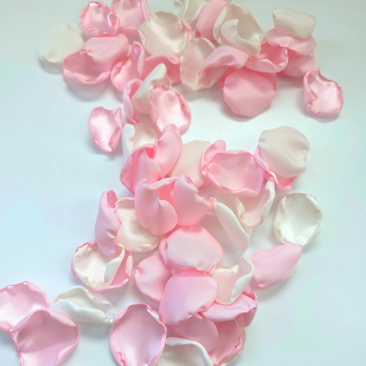 A mix of pink and white rose petals for a future bride using a pink wedding color palette. For flower girl toss, aisle decor, tablescape decor ideas or confetti scatter.