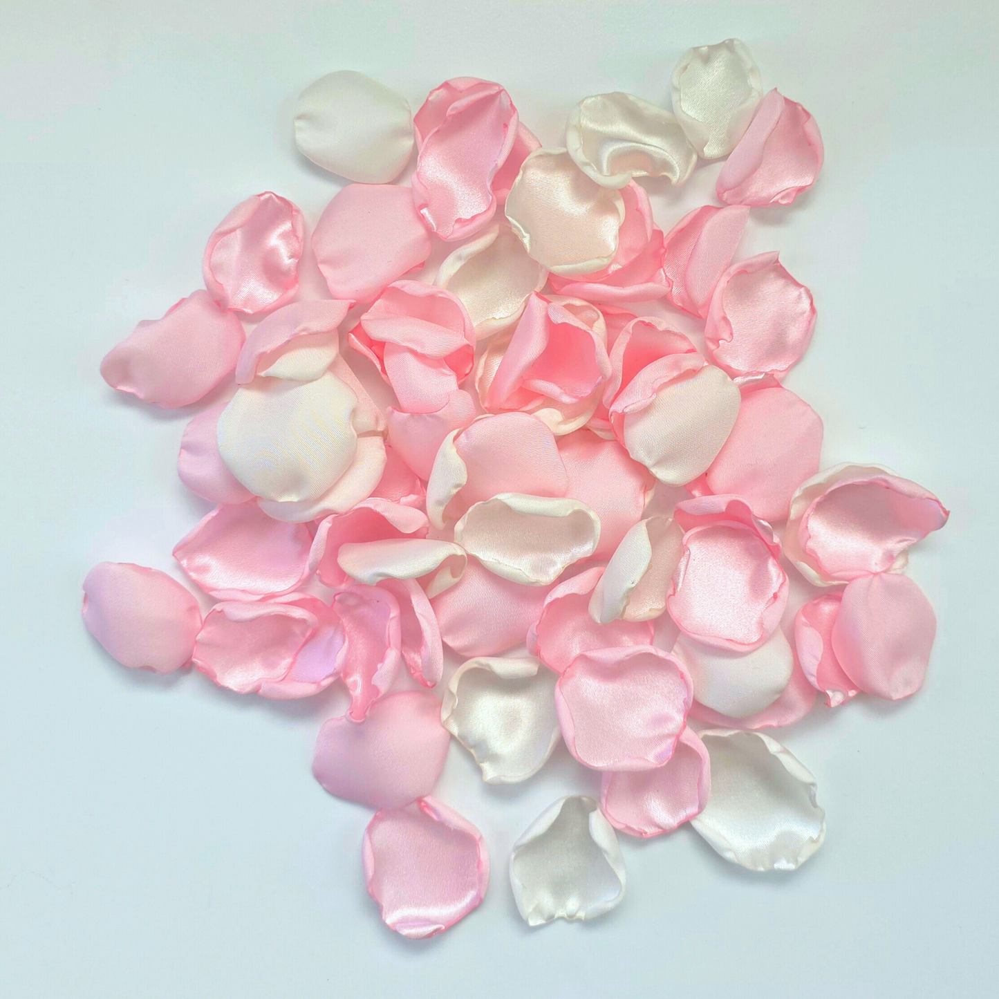 A mix of pink and white rose petals for a future bride using a pink wedding color palette. For flower girl toss, aisle decor, tablescape decor ideas or confetti scatter.