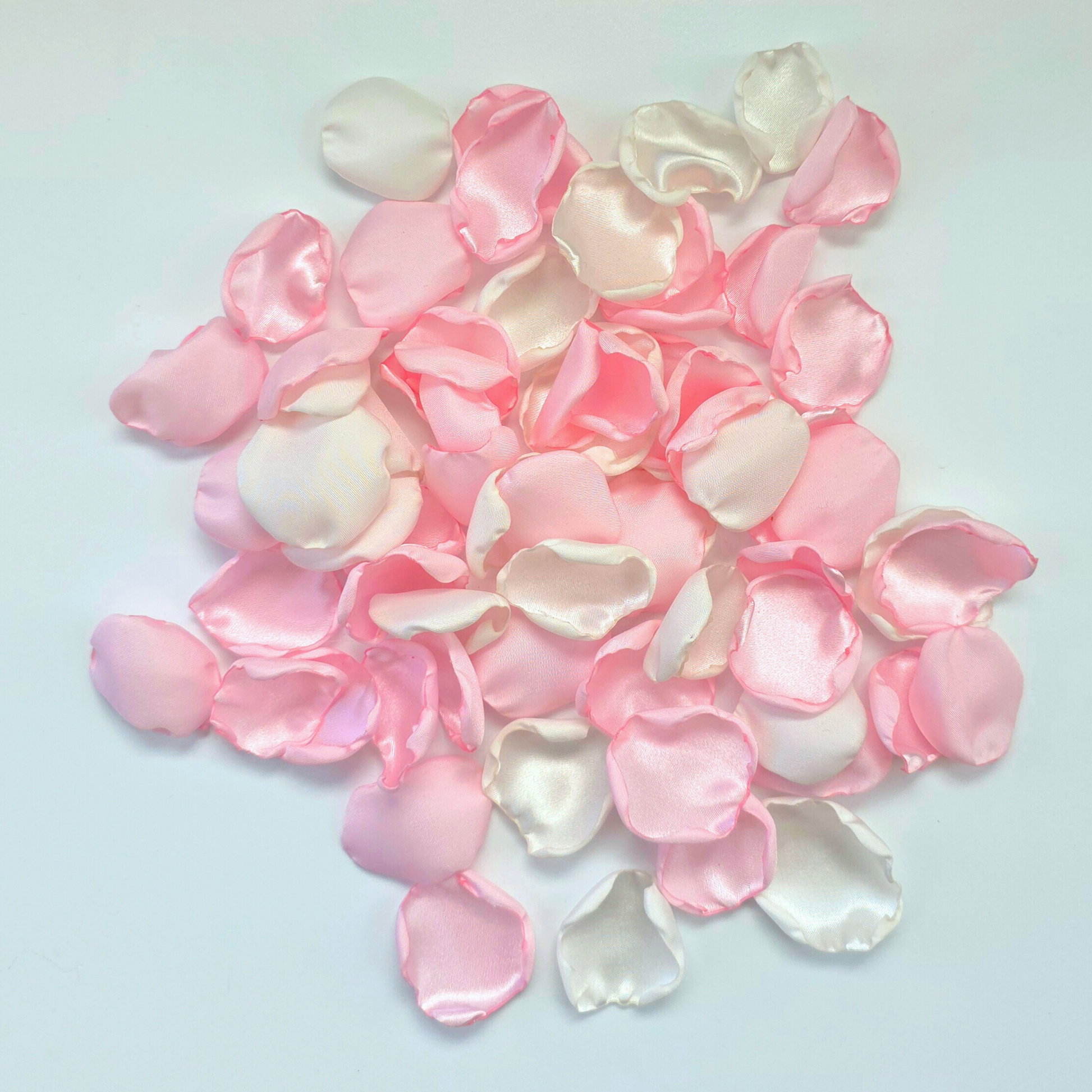 A mix of pink and white rose petals for a future bride using a pink wedding color palette. For flower girl toss, aisle decor, tablescape decor ideas or confetti scatter.