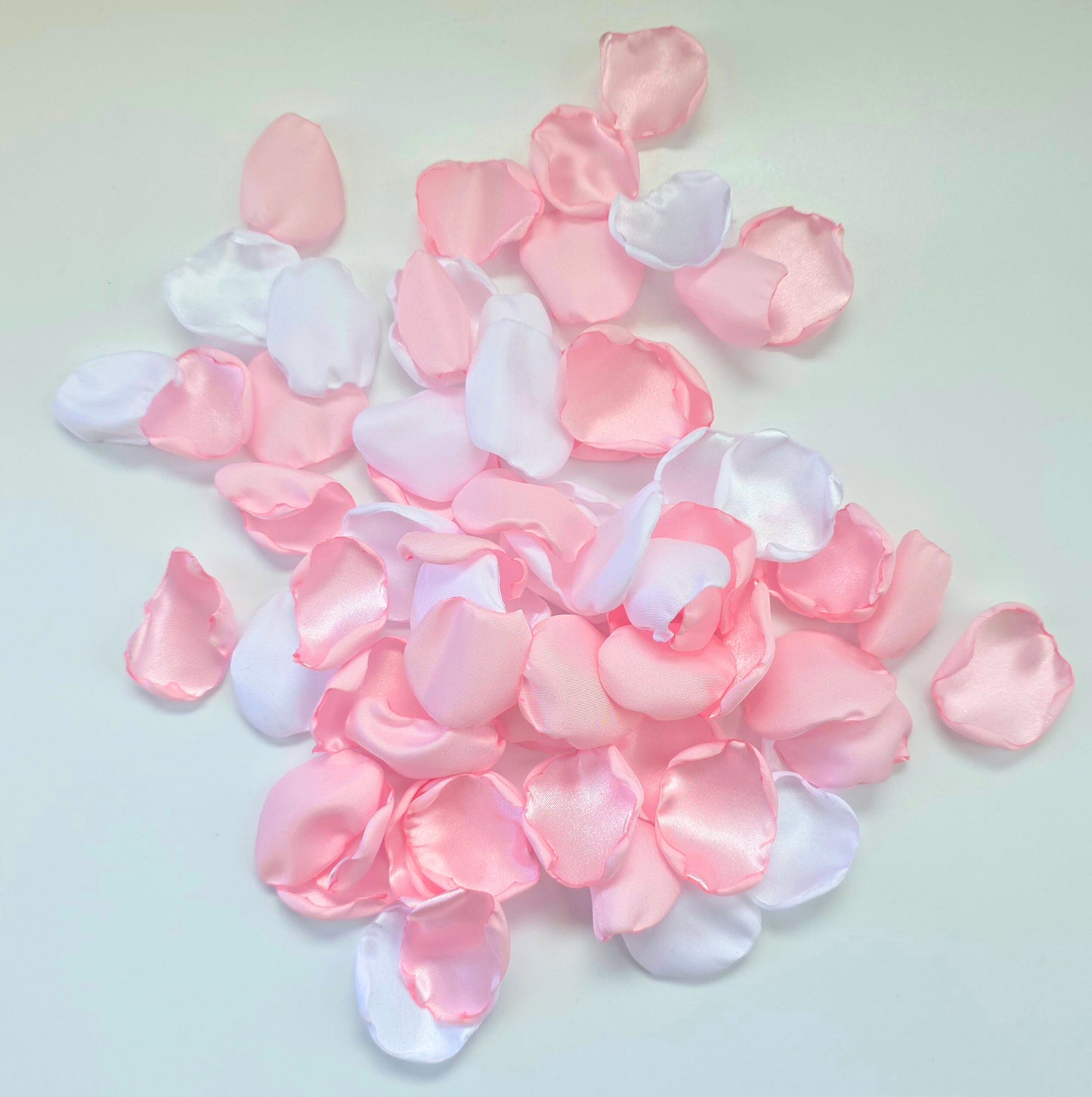 A mix of pink and white rose petals for a future bride using a pink wedding color palette. For flower girl toss, aisle decor, tablescape decor ideas or confetti scatter.