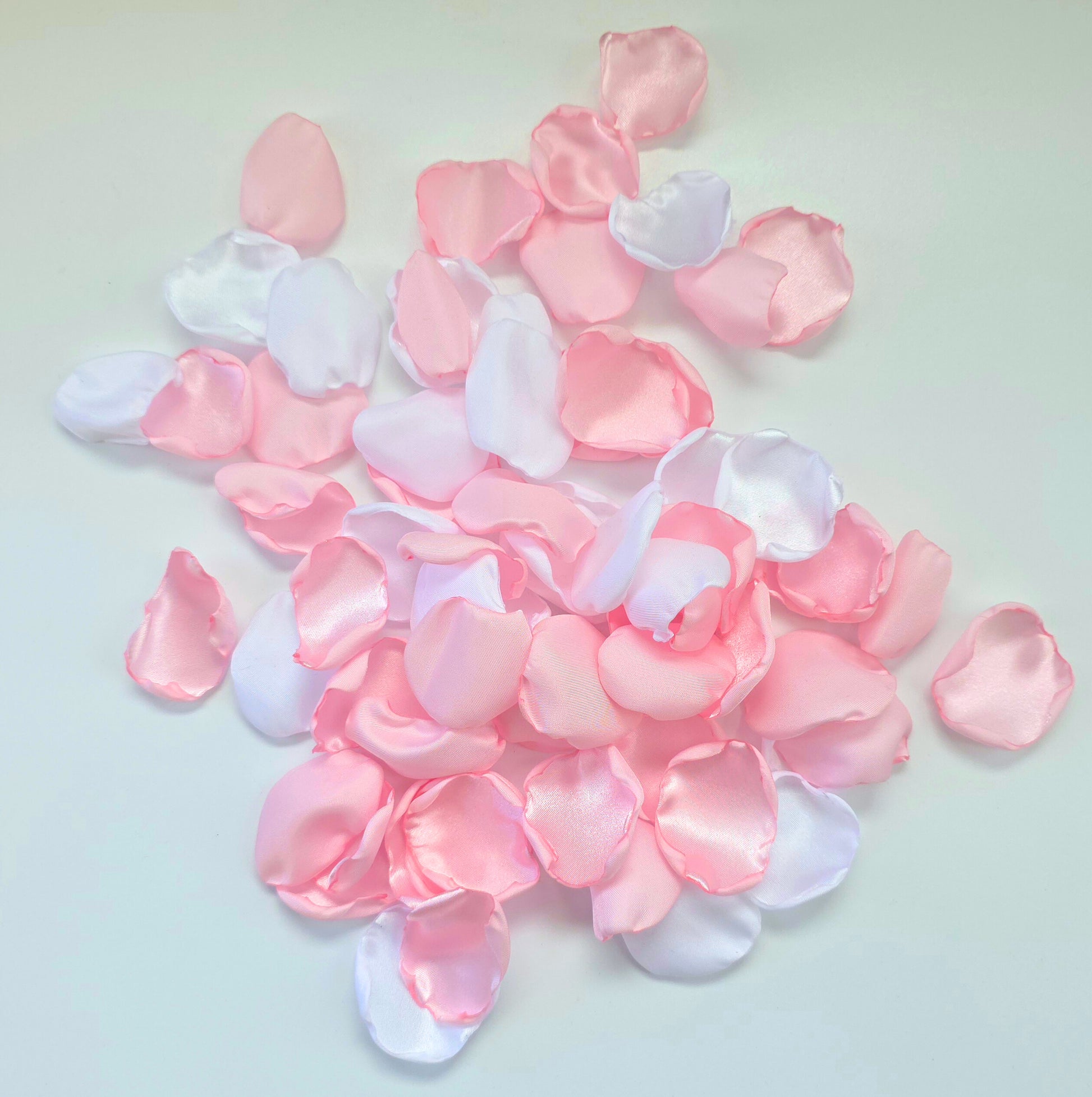 A mix of pink and white rose petals for a future bride using a pink wedding color palette. For flower girl toss, aisle decor, tablescape decor ideas or confetti scatter.