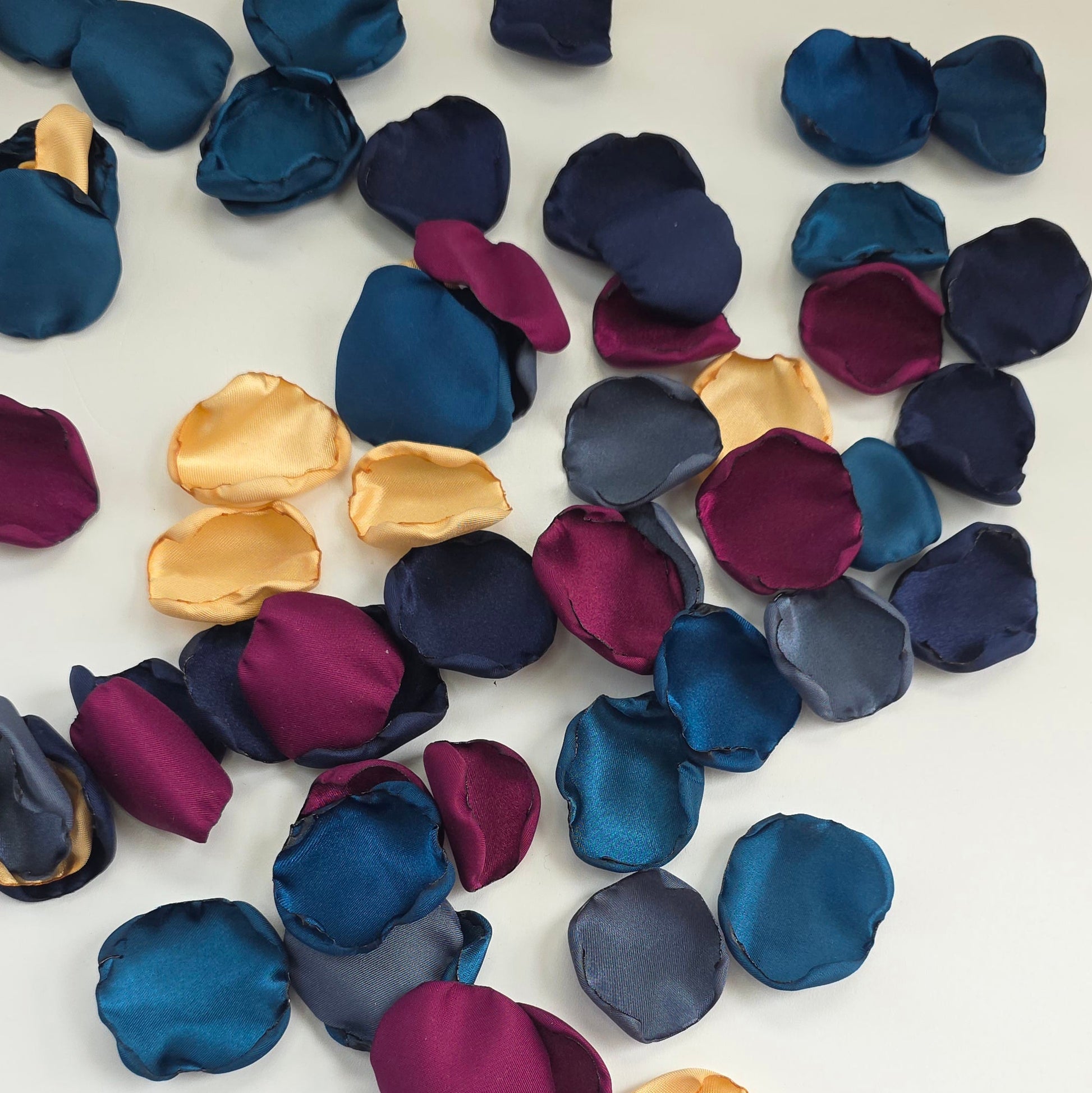 Teal Fig Mulberry, gold, navy and stormy blue rose petals for a twilight starry night, celestial themed wedding ceremony or bridal shower table scatter, confetti. A Fall color palette for a future bride planning a jewel-toned wedding.