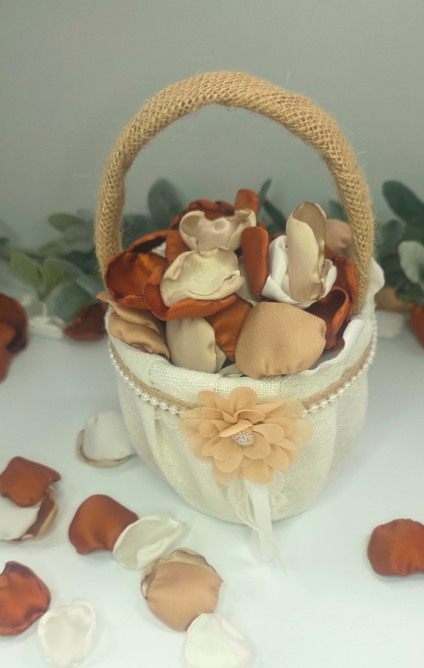 A rustic flower girl basket with A mix of rose petals featuring an Auburn, terracotta, burnt orange color palette that includes beige, taupe and off white petals. Perfect for flower girl baskets and tossing, aisle decor, flatlays, reception tablescape decorations, table scatter and confetti toss. Ideas for the future bride planning a fall wedding ceremony or a boho western bridal shower event.