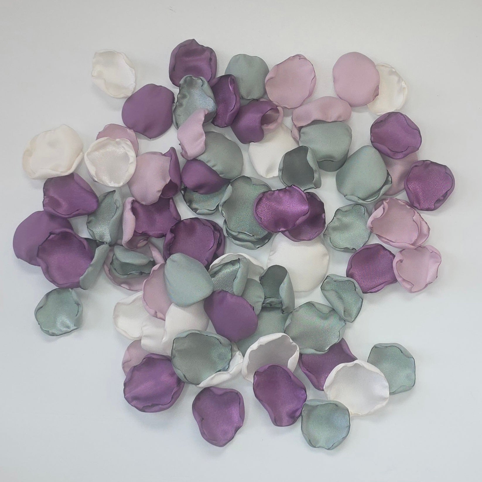 A mix of different shades of purple and sage green rose petals. Includes Wisteria, Dusk Purple, Ivory and dusty sage rose petals for flower girl toss, aisle decor, photo flatlays, table scatter. Perfect for future brides planning a classic wedding or Love in Bloom bridal shower event.