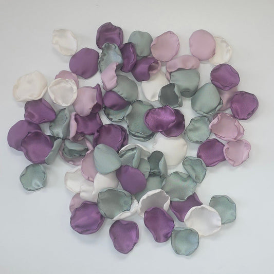 A mix of different shades of purple and sage green rose petals. Includes Wisteria, Dusk Purple, Ivory and dusty sage rose petals for flower girl toss, aisle decor, photo flatlays, table scatter. Perfect for future brides planning a classic wedding or Love in Bloom bridal shower event.