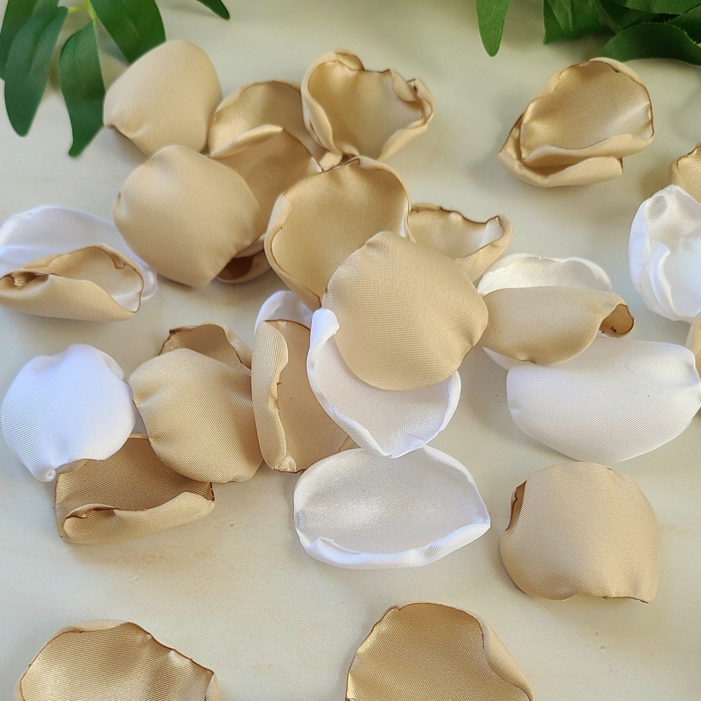 Beige and white flower petals used as wedding decor on a reception table