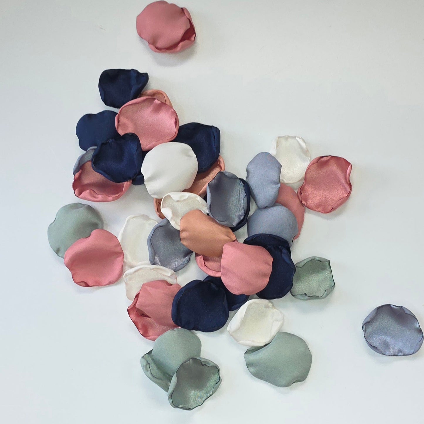 A mix of Dusty Blue, Navy, Dusty Rose, champagne rose pink, dusty sage rose petals. Perfect for flower girl tossing, aisle decor, inspo for wedding decor, tablescape scatter or backdrop accents. A color palette for a future bride planning a wedding ceremony or bridal shower brunch event.