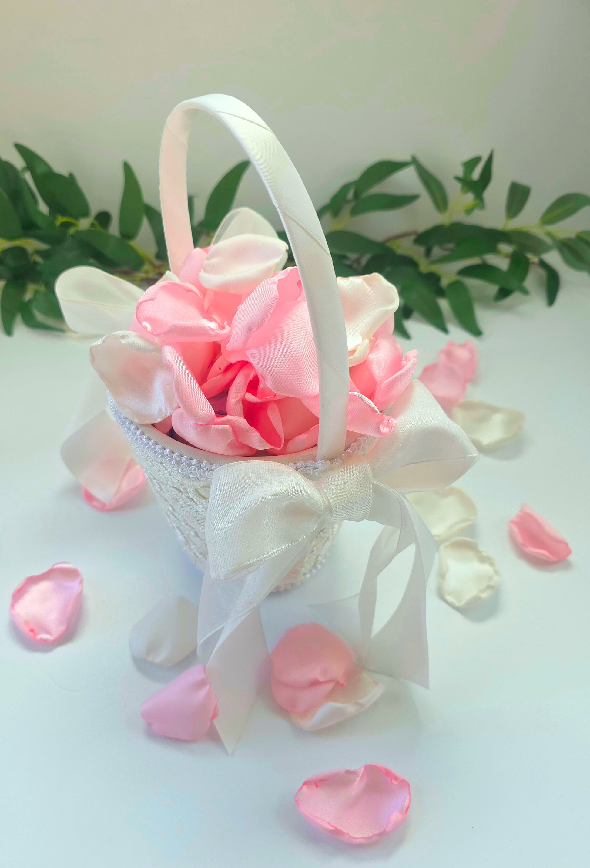 A mix of pink and white rose petals in a flower girl basket. for future brides using a pink wedding color palette. For flower girl toss, aisle decor, tablescape decor ideas or confetti scatter.