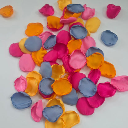 A mix of Tangerine Mango Orange, Fuchsia, Candy pink, sunset orange and dusty blue rose petals. Perfect for aisle decor, flower girl tossing. table scatter, backdrop accents or photo flatlays ideas. A golden hour, topical, and sunset vibes for a future bride planning a wedding ceremony or bridal shower event. A bold colorful, modern color palette inspiration and wedding decor ideas. 